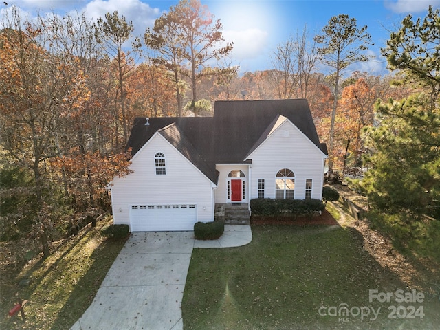 view of front of house featuring a front yard and a garage