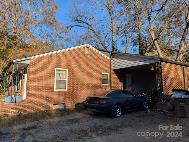 view of property exterior with a carport