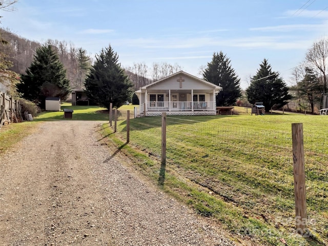 ranch-style home featuring a porch and a front yard