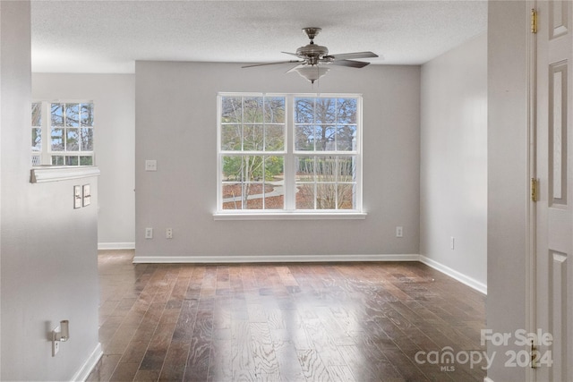 spare room featuring hardwood / wood-style flooring, ceiling fan, and a textured ceiling