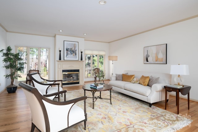 living room with hardwood / wood-style flooring, crown molding, and a wealth of natural light