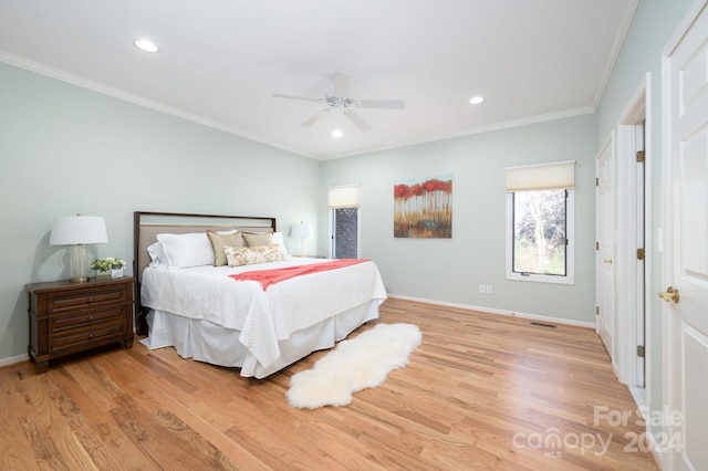 bedroom with ceiling fan, light wood-type flooring, and ornamental molding