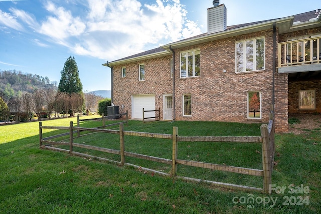 view of property exterior with a garage, cooling unit, and a lawn