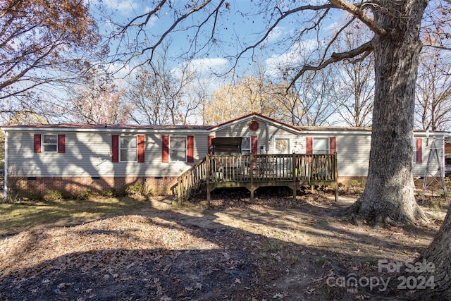 back of house featuring a wooden deck