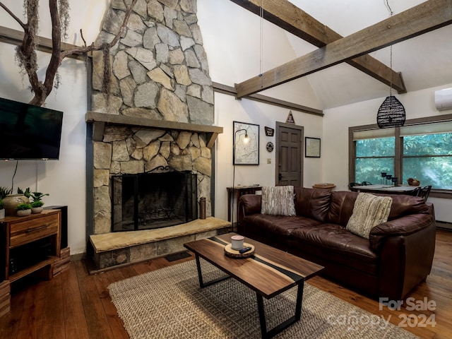 living room featuring beam ceiling, high vaulted ceiling, a wall unit AC, hardwood / wood-style floors, and a fireplace