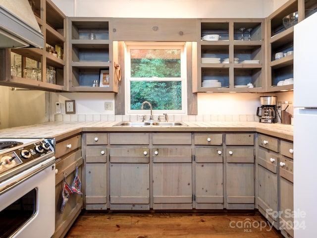 kitchen with white appliances, gray cabinets, dark wood-type flooring, and sink