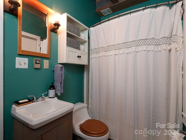 bathroom with a shower with curtain, vanity, and toilet