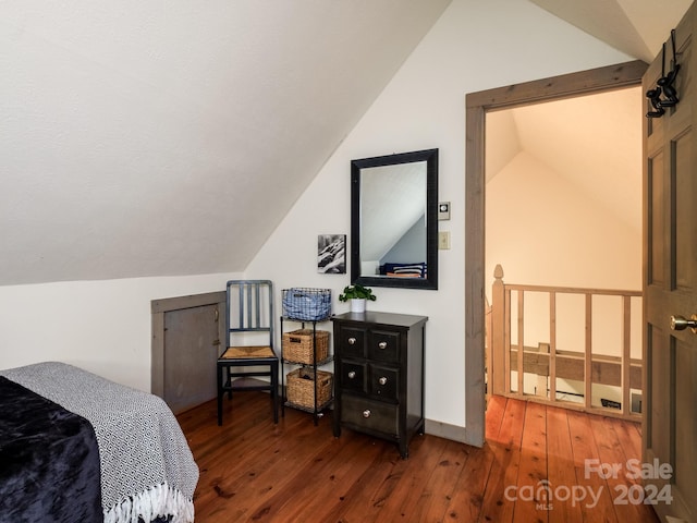 bedroom featuring lofted ceiling and dark wood-type flooring