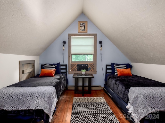 bedroom featuring dark hardwood / wood-style floors, lofted ceiling, and a baseboard heating unit