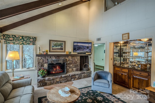 carpeted living room featuring beamed ceiling, high vaulted ceiling, and a fireplace