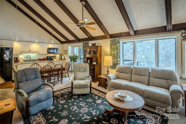 300 Glenwood Ln Unit K-38, Sugar Mountain, NC 28604 - living room featuring beam ceiling, a ceiling fan, and high vaulted ceiling