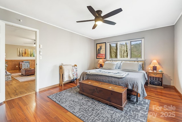 bedroom featuring hardwood / wood-style floors, ceiling fan, and ornamental molding