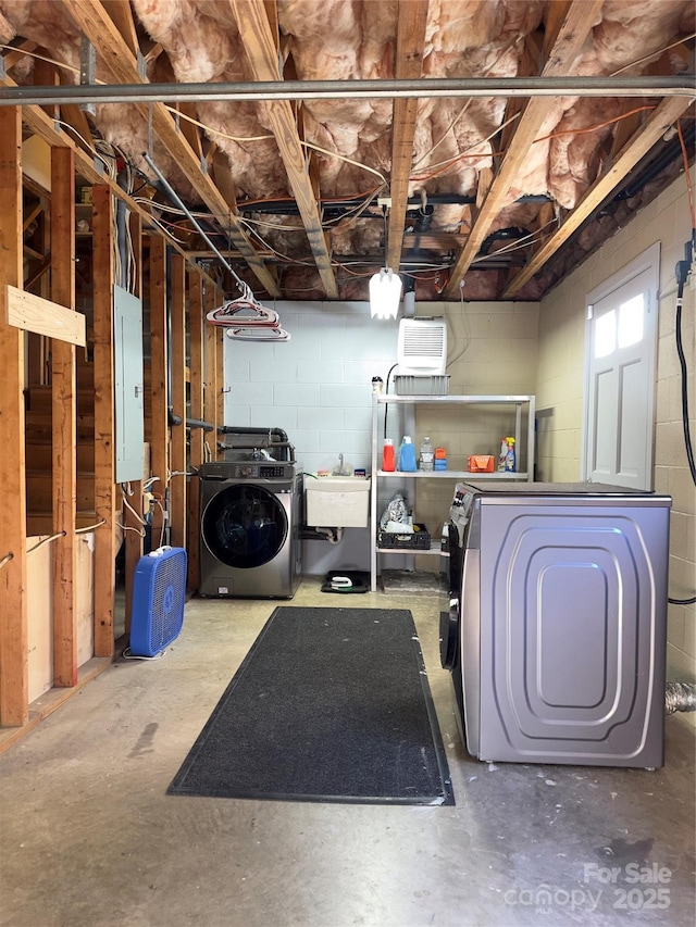 basement with electric panel, sink, and independent washer and dryer