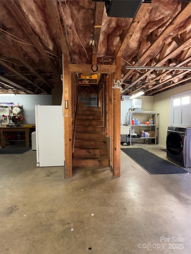 basement with white fridge and washing machine and dryer