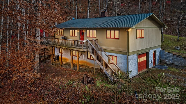 exterior space with a garage and a deck