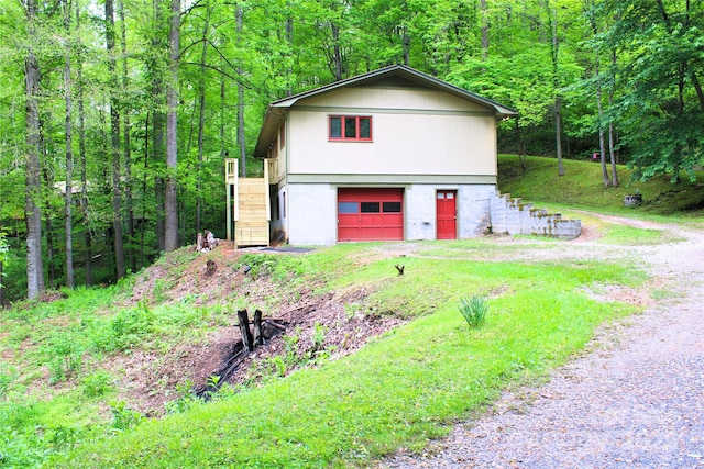 exterior space with driveway and a forest view