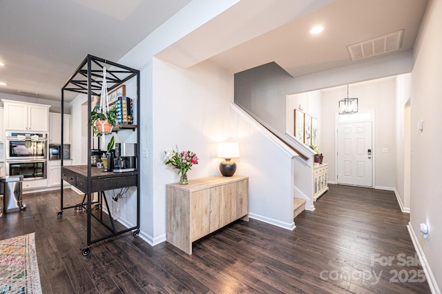 foyer entrance featuring recessed lighting, visible vents, stairway, dark wood-type flooring, and baseboards