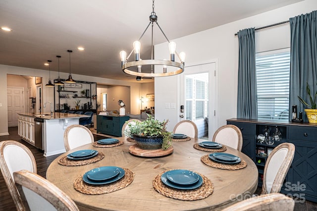 dining space with dark wood finished floors, a notable chandelier, and recessed lighting