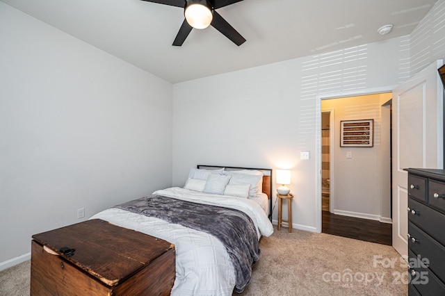 carpeted bedroom with ceiling fan and baseboards