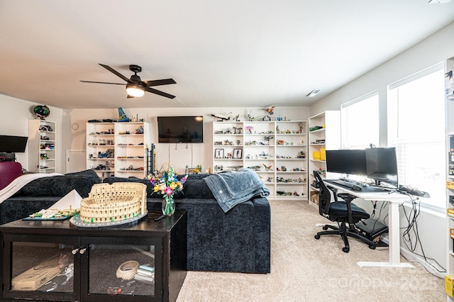 living area featuring a ceiling fan and light colored carpet