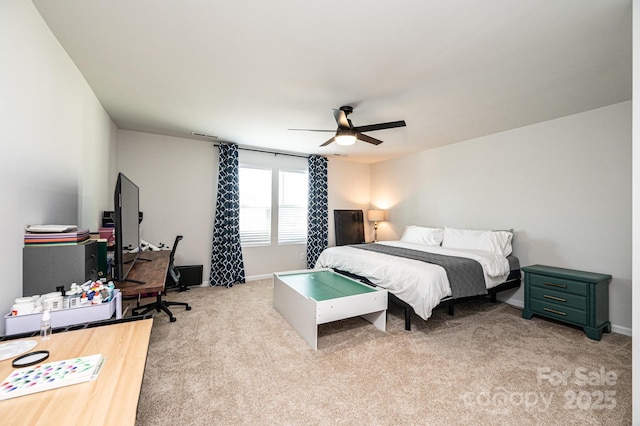 bedroom with light carpet, baseboards, and a ceiling fan