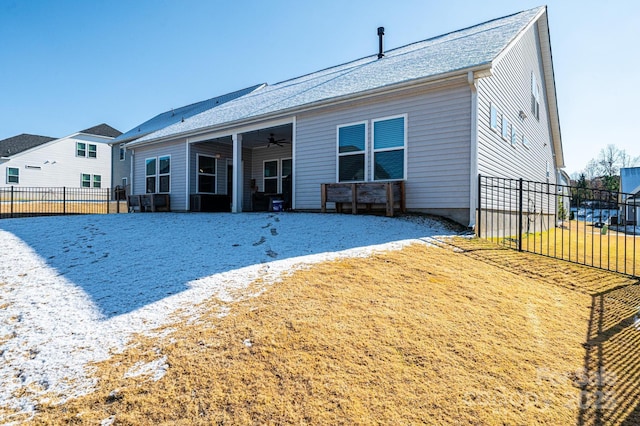 rear view of house with ceiling fan and fence