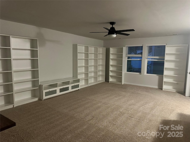 interior space with carpet flooring and ceiling fan