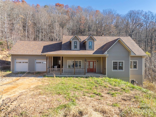 view of front of home featuring a porch and a garage