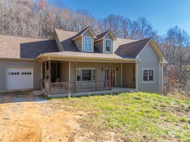 view of front of property featuring covered porch and a garage