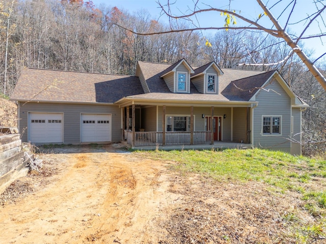 view of front facade featuring covered porch and a garage