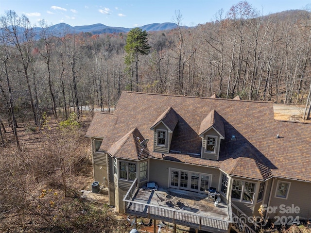 back of house with a deck with mountain view and central air condition unit