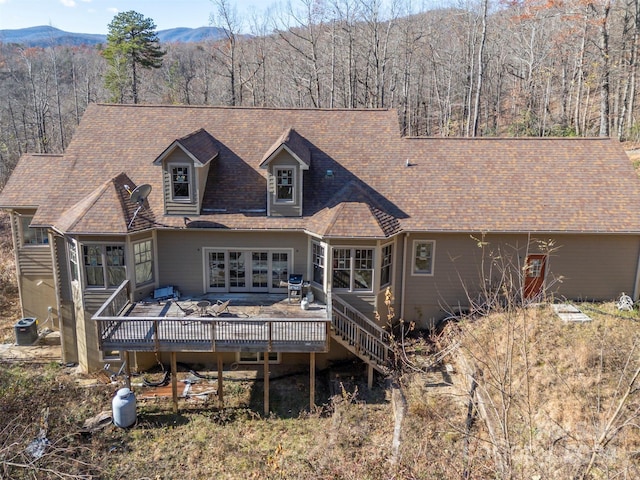 rear view of property featuring a deck with mountain view