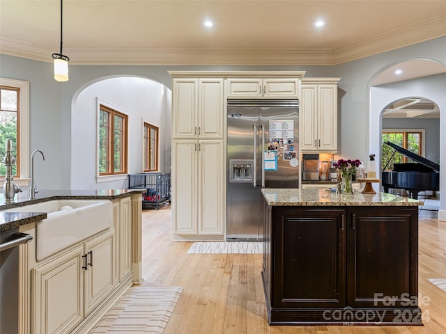 kitchen featuring cream cabinetry, plenty of natural light, and appliances with stainless steel finishes