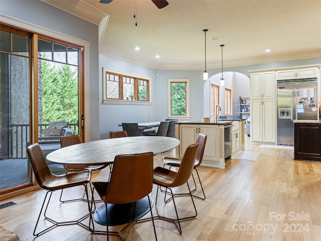 dining room with ceiling fan, light hardwood / wood-style flooring, and ornamental molding