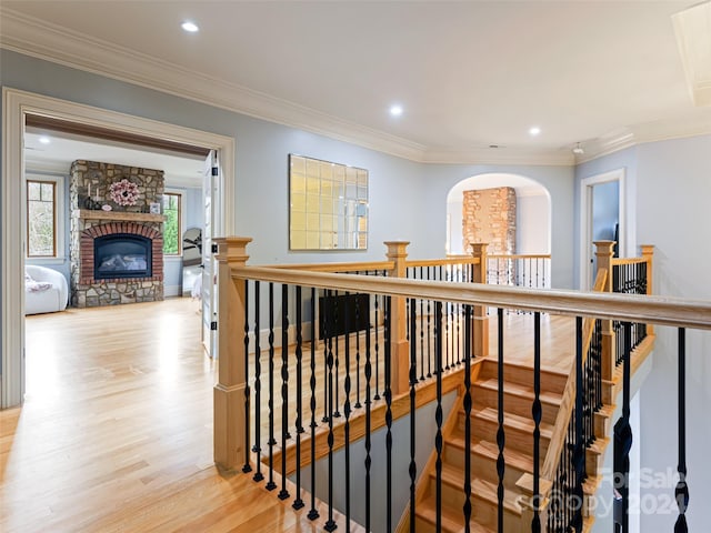 corridor featuring light hardwood / wood-style floors and crown molding