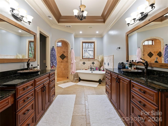 bathroom featuring vanity, a tray ceiling, crown molding, tile walls, and a notable chandelier