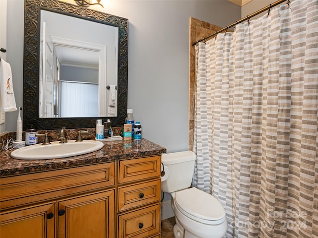 bathroom featuring toilet, vanity, and ornamental molding