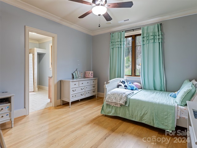 bedroom with ceiling fan, light wood-type flooring, and crown molding