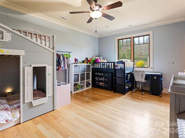 bedroom featuring hardwood / wood-style flooring, ceiling fan, and crown molding