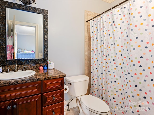 bathroom featuring vanity, toilet, curtained shower, and crown molding