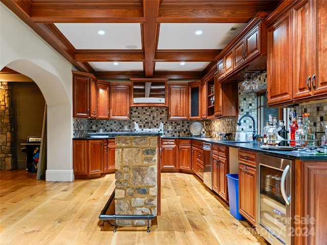 kitchen with backsplash, a center island, beverage cooler, and light wood-type flooring