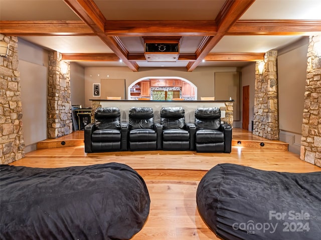 cinema room with beamed ceiling, hardwood / wood-style flooring, and coffered ceiling