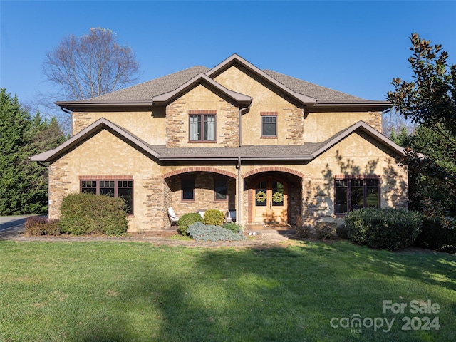 view of front of house with a front lawn and a porch