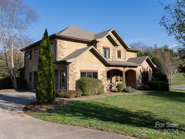 view of front of property with covered porch and a front lawn