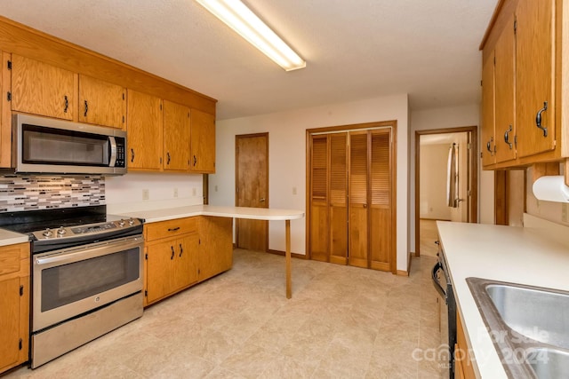 kitchen with decorative backsplash, stainless steel appliances, and sink