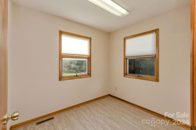 spare room featuring light hardwood / wood-style flooring