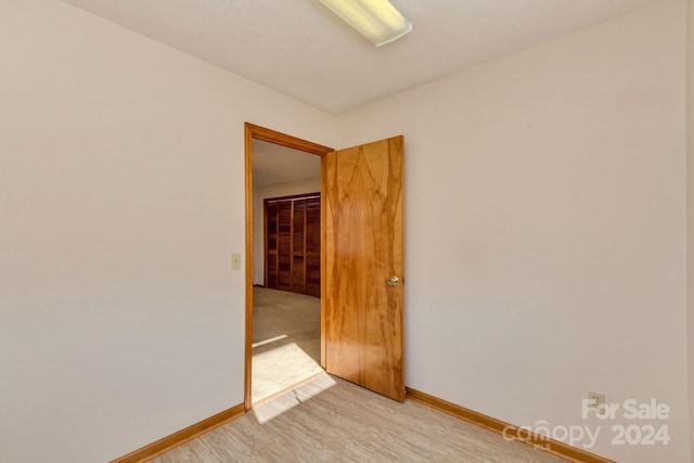 unfurnished room with light hardwood / wood-style flooring