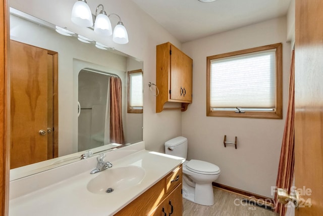 bathroom with toilet, vanity, a shower with shower curtain, and hardwood / wood-style flooring