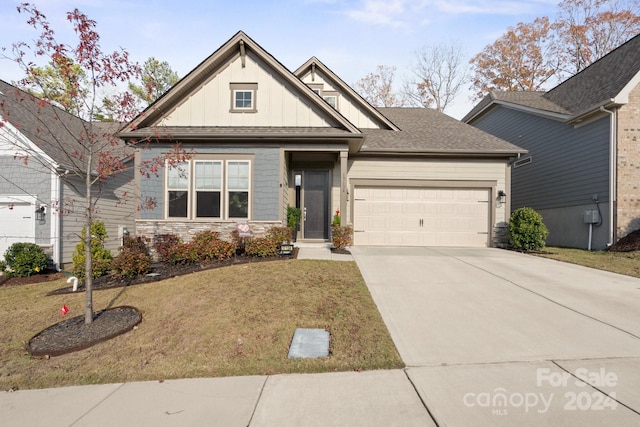 view of front of home with a garage and a front lawn