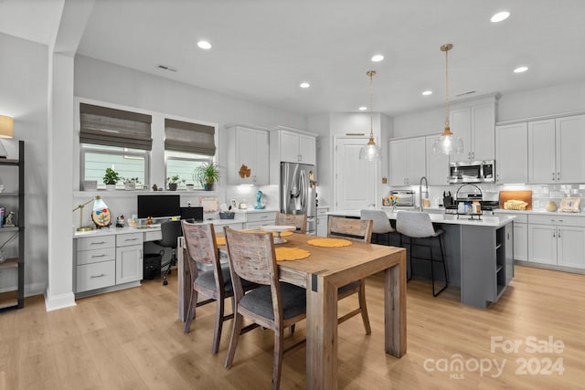 dining area featuring light wood-type flooring